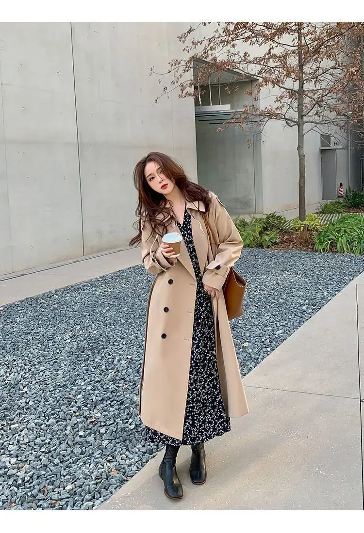 Beige women double-breasted trench coat with black buttons designed as a casual windbreaker.