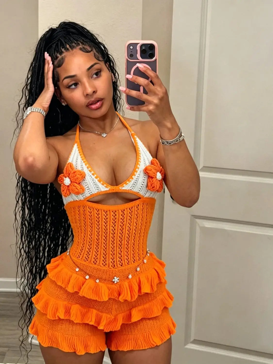 Orange and white crocheted knitted ruffle halter romper summer playsuit with floral embellishments.