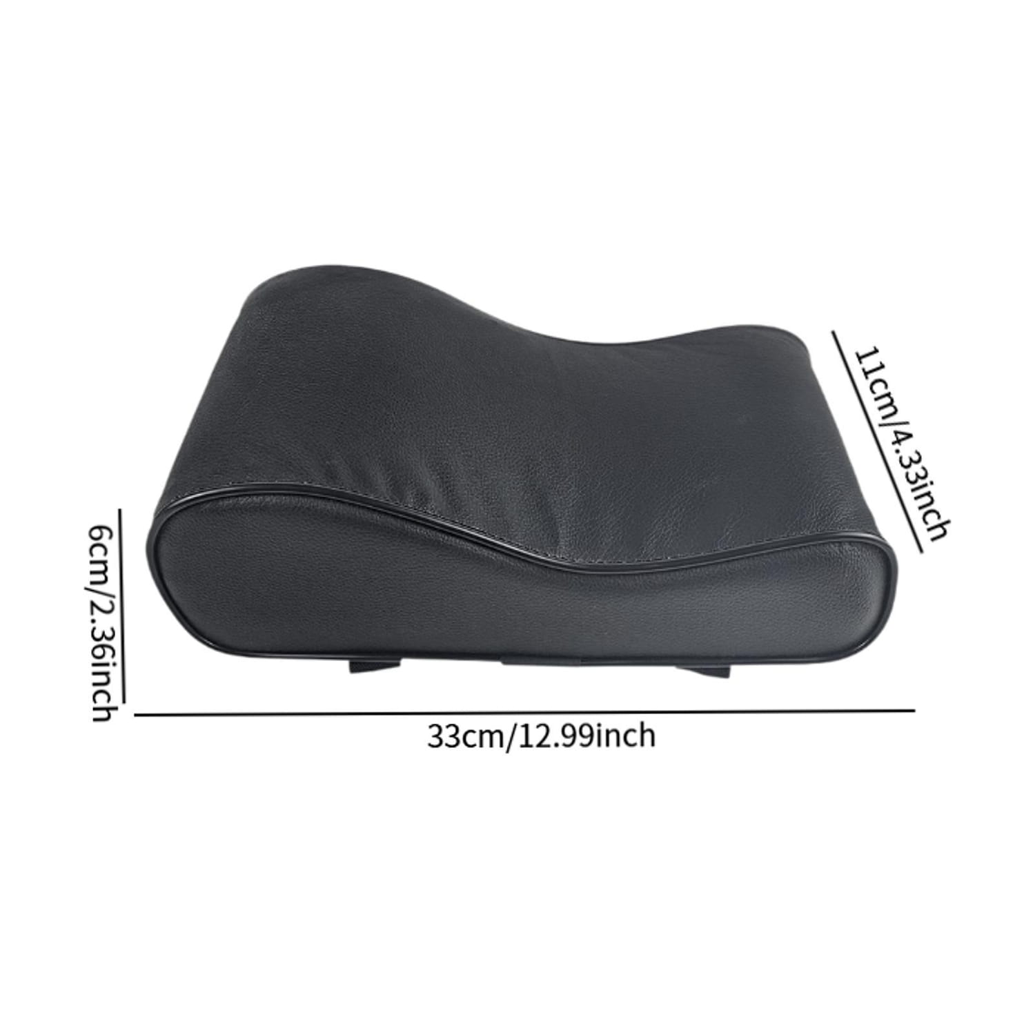Black leather neck support pillow with a contoured design for Pilates reformer providing ergonomic neck support.