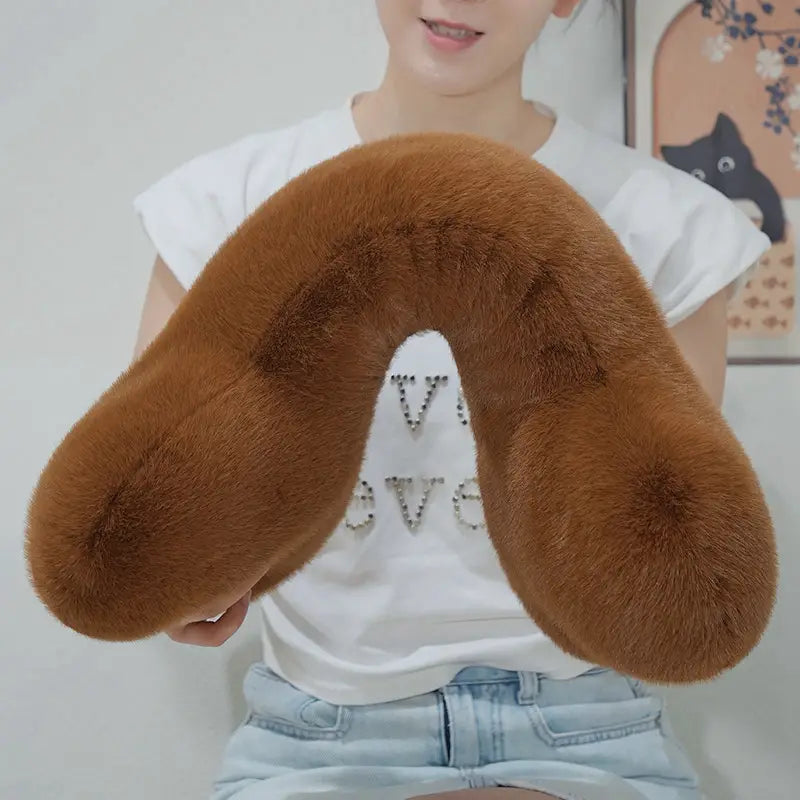 brown faux fur bone shape plush travel neck pillow with soft plush texture and subtle rhinestone detailing designed as a kawaii bone shape plush soft nap cushion