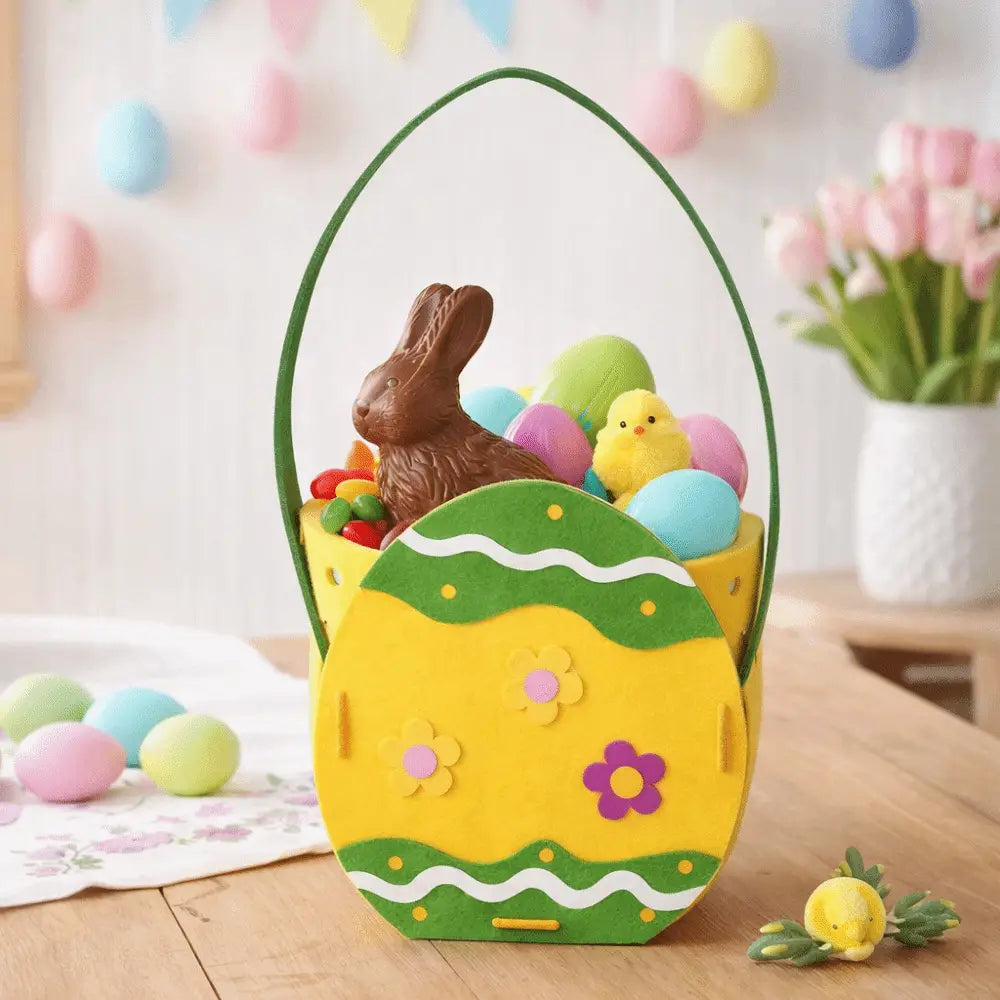 A cheerful yellow and green felt Easter bunny basket gift bag shaped like an egg with floral decorations filled with colorful eggs and a chocolate bunny.