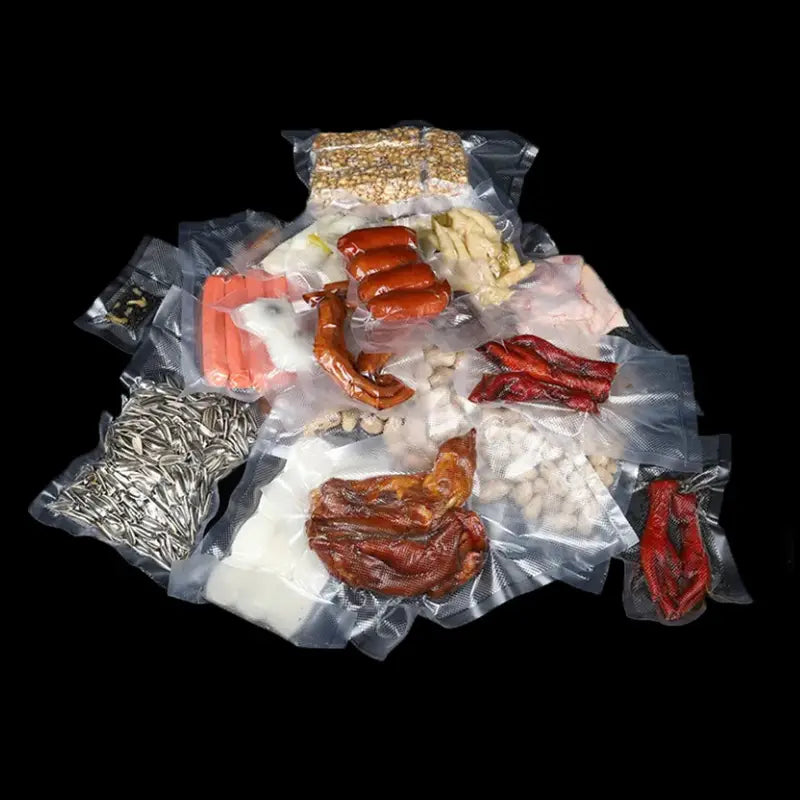 Eine Zusammenstellung verschiedener Lebensmittel einschließlich Würstchen, getrockneter Chilischoten, Nüssen und Fleisch, vakuumversiegelt in transparenten strukturierten Vakuumbeuteln 12x20 cm, ausgelegt für die Lebensmittelversiegelung für 100 Stk.