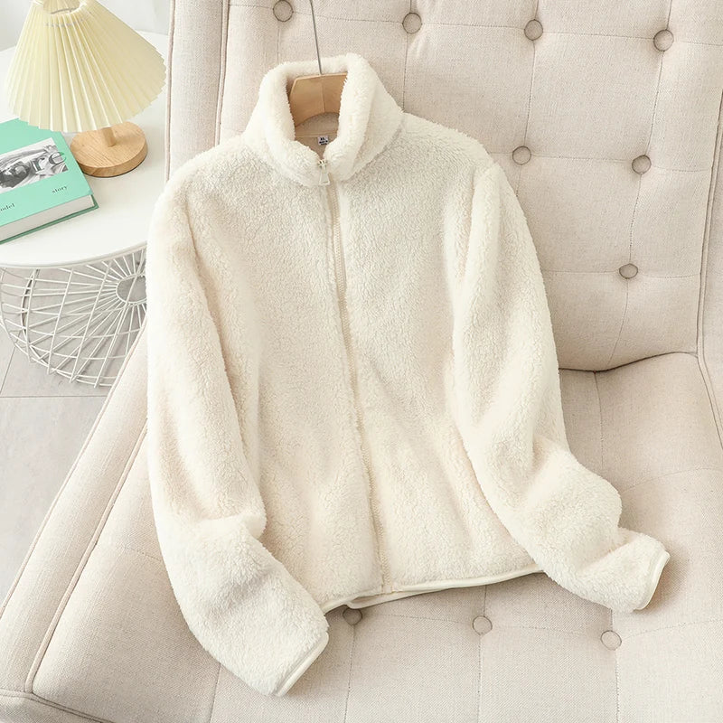 Women reversible fleece winter coat in cream color featuring a plush faux fur zip-up design with a high collar and soft texture.