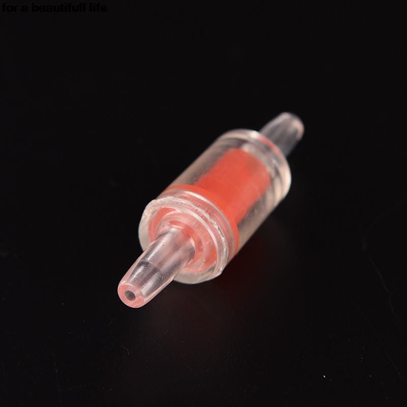 Válvula de retención de plástico transparente para bomba de aire de acuario con componente interno rojo y cuerpo cilíndrico transparente, diseñada como accesorio para bomba de aire unidireccional.