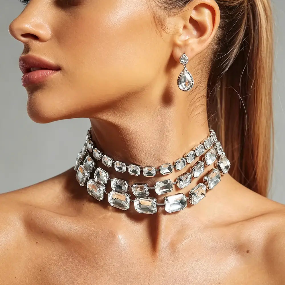 A multi-layered crystal statement choker necklace for women featuring clear rectangular-cut crystals set in a silver-toned metal frame.