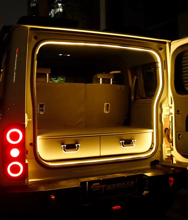 The rear of a beige suv with illuminated storage drawers and red circular taillights showcasing car trunk lighting fit for modified auto trunk use in the Baic 212 T01 2024.
