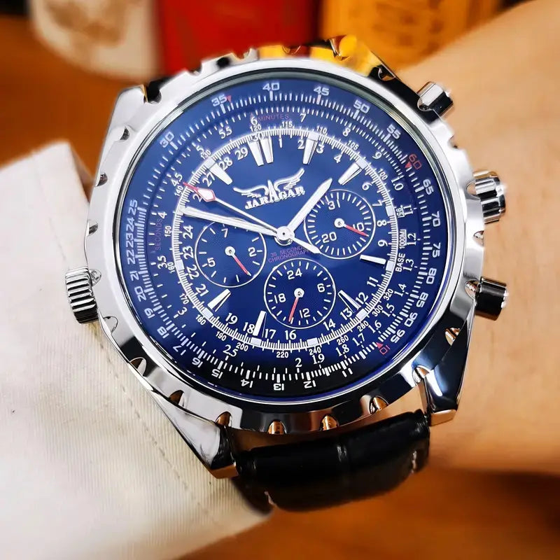 A sleek silver jaragan mechanical stainless steel men’s chronograph watch with a deep blue dial, black leather strap, and multiple subdials for precise timekeeping.