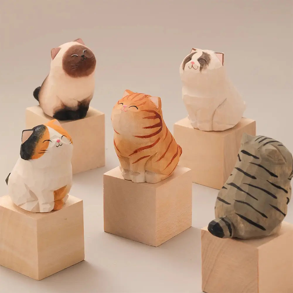 handcrafted wooden cat figurine desk decor featuring cute factory direct wooden cats in various colors and patterns each sitting on a small cube base as an actual product for desk decoration