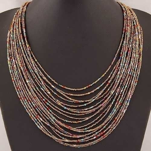 Boho multi-layer bead statement necklace featuring a multi-strand design with tiny cylindrical beads in earthy tones of brown red and beige.