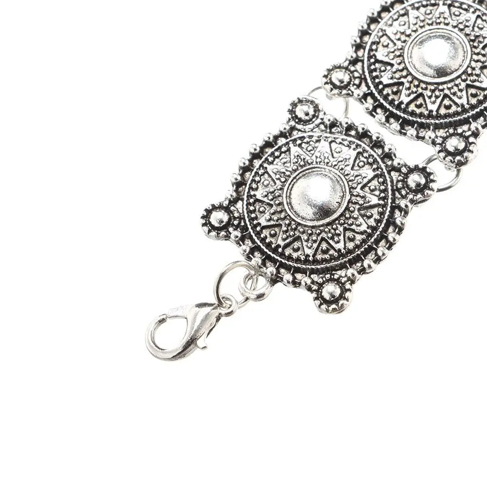 Silver-toned boho vintage bracelet featuring intricate ornate circular medallions with detailed geometric and sunburst patterns.