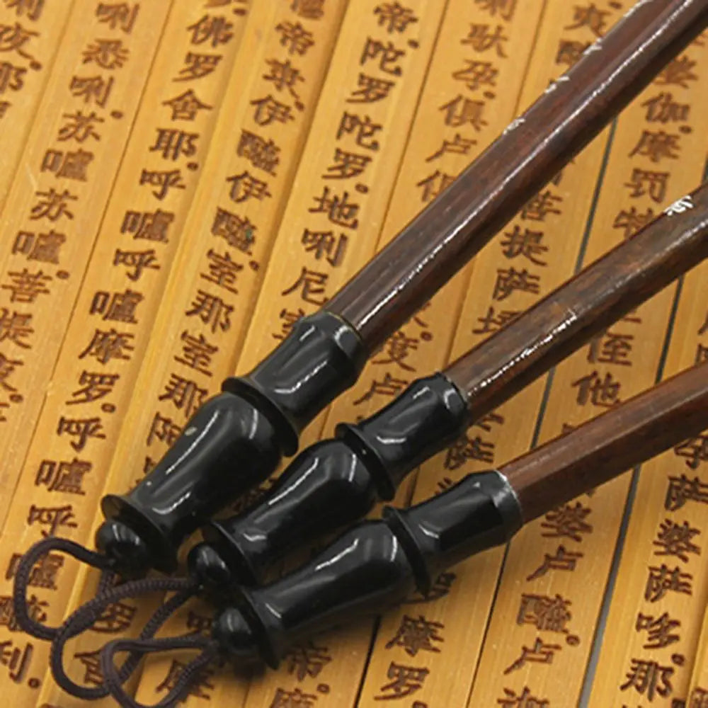 dark brown wooden chopsticks with glossy black lacquered handles and a braided cord loop from the chinese calligraphy brush set 6 piece writing practice.