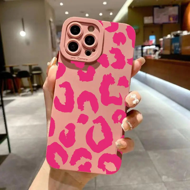 pink leopard-print matte phone case shown from the back designed as a camera protective iphone case with a matte black finish