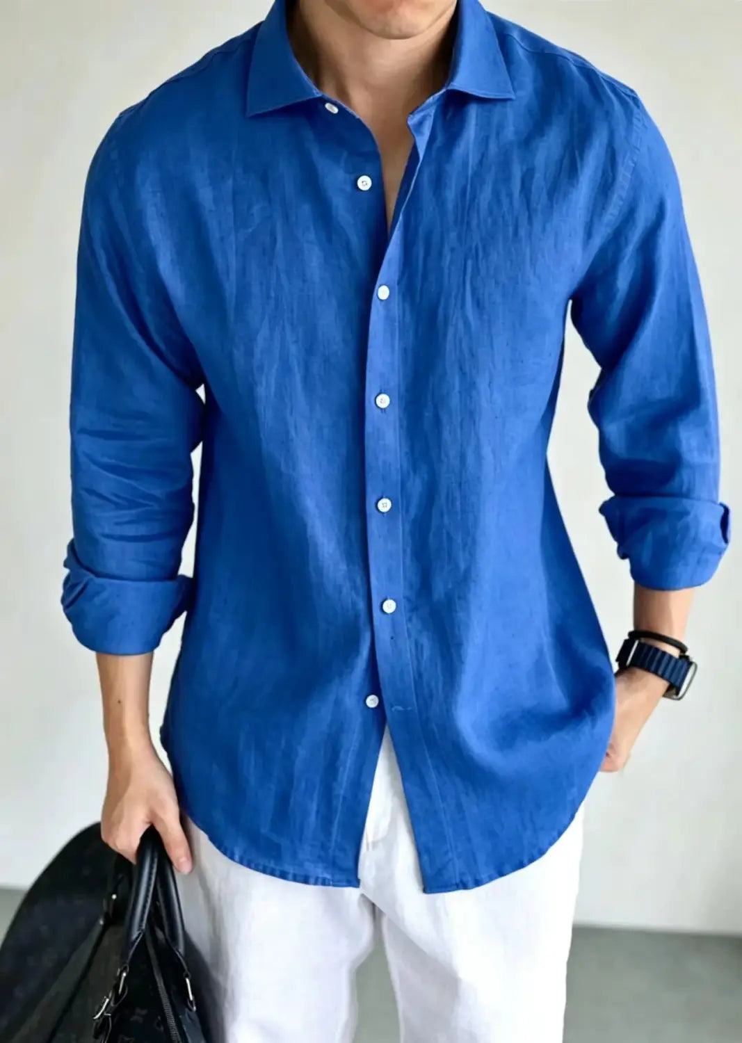 A vibrant royal blue men cotton linen casual button down shirt with a classic collar, button front, and rolled-up sleeves.