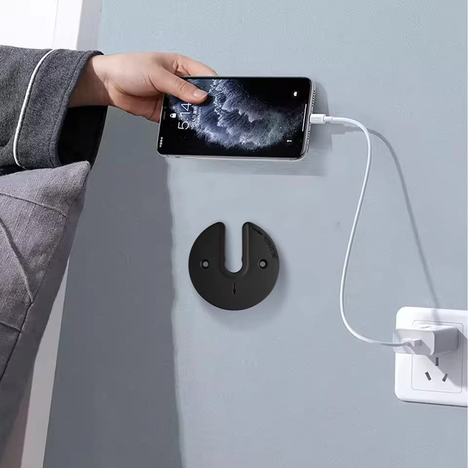 black circular wall-mounted tablet wall charger holder made of durable material featuring a u-shaped slot for securing devices, ideal for organizing card board and routers