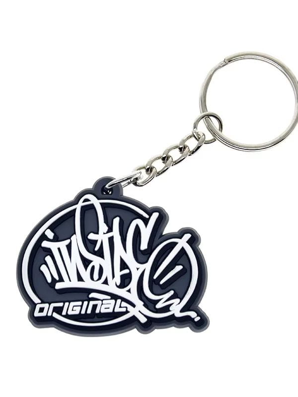 Black rubber custom soft PVC keychain with white graffiti style original logo attached to a silver chain and ring personalized rubber key ring.