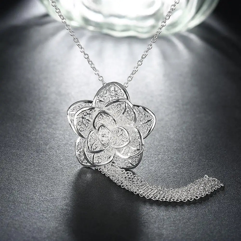 Collier pendentif en argent sterling en forme de fleur, avec une chaîne délicate et un gland en maille retombant, provenant de la parure de bijoux floraux en argent sterling.