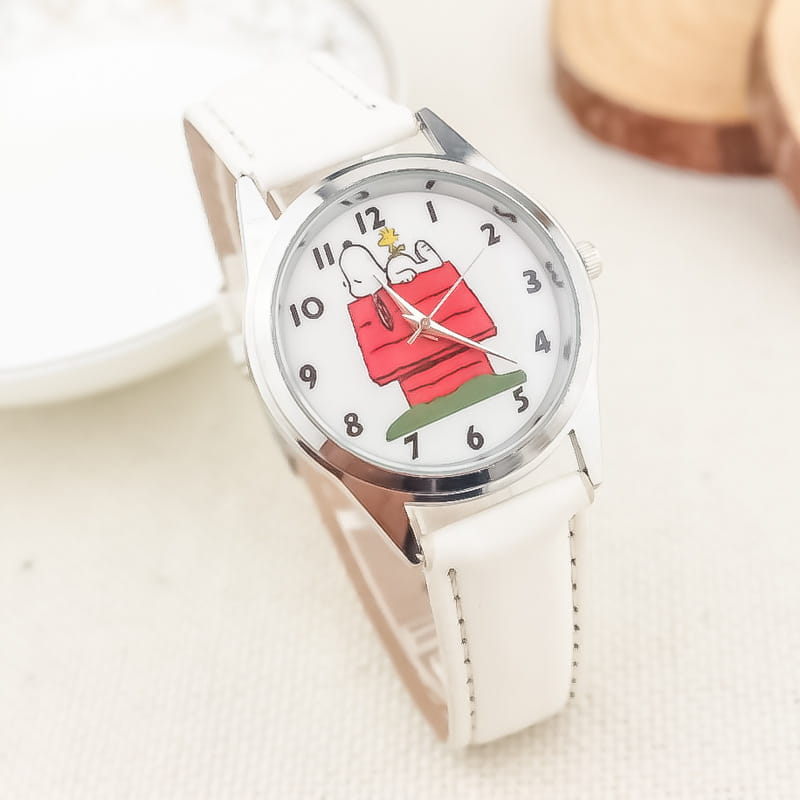 white leather strap snoopy quartz watch with silver-toned case and white dial featuring snoopy in his red doghouse cartoon design