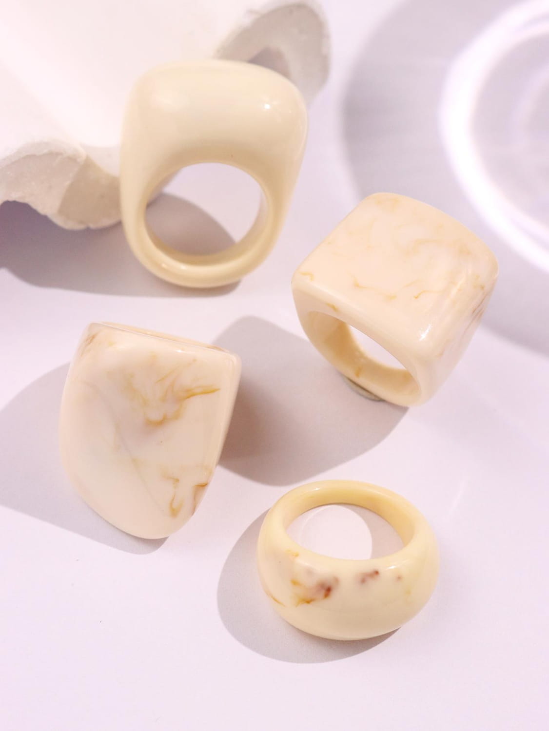 Cream-colored marbled resin chunky cocktail rings 4-piece set with smooth glossy finish and bold geometric shapes.