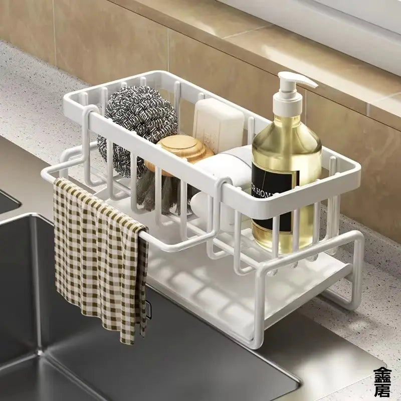 White plastic sink organizer with drainage rack, featuring a grid design, lower shelf, and upper compartment for cleaning supplies.