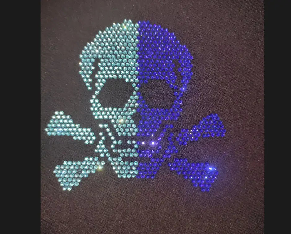 men rhinestone devil bear graphic tee featuring a sparkling skull and crossbones design adorned with teal and blue rhinestones on dark fabric