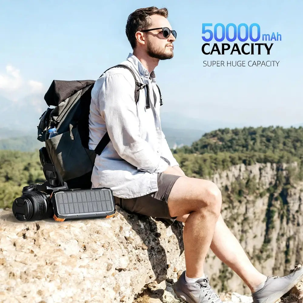 black and orange solar-powered portable charger with 50000 mah capacity and hand crank feature for emergency power backup