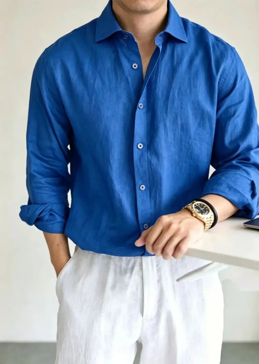 A vibrant royal blue men cotton linen casual button down shirt with a classic collar and neatly rolled sleeves.