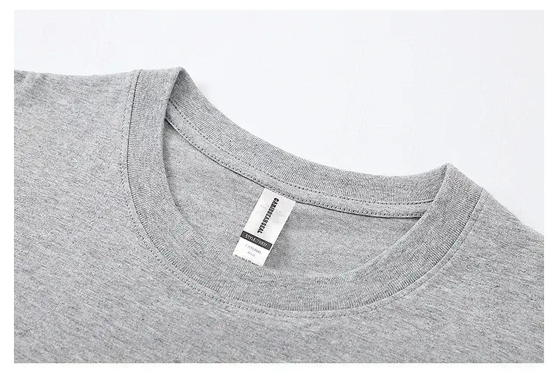 T-shirt vintage à motif de voiture de muscle en coton chiné gris, avec un col ras du cou simple et une étiquette d’entretien blanche cousue à l’intérieur du col.