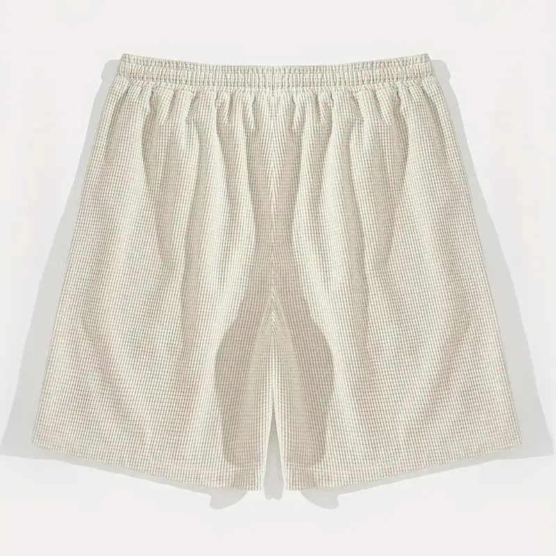 Beige Herren-Waffelstrick-Freizeit-Badeshorts mit elastischem Bund und strukturiertem Strickstoff.