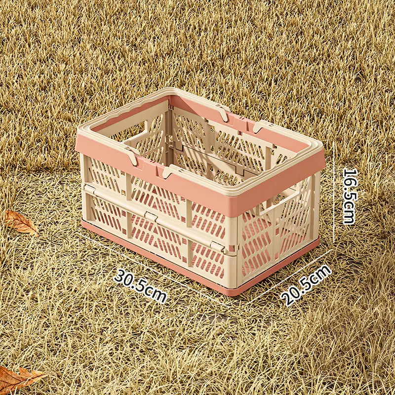 A pink and beige foldable plastic shopping basket with a lattice design for collapsible storage and transport.