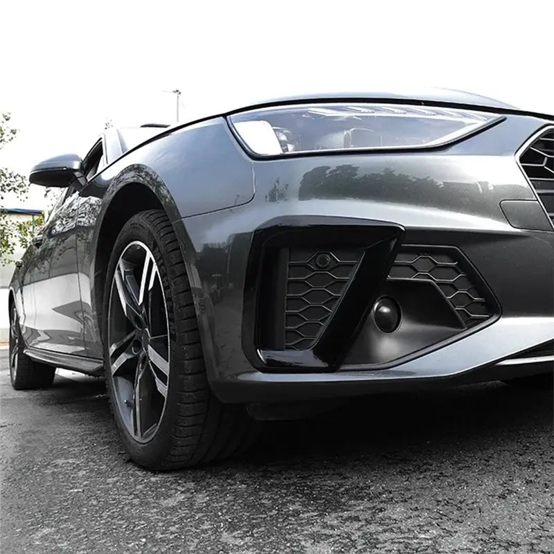 Audi A4 B9 fog lamp cover 2020 2024 black matte finish front bumper with honeycomb mesh design and integrated fog light housing.