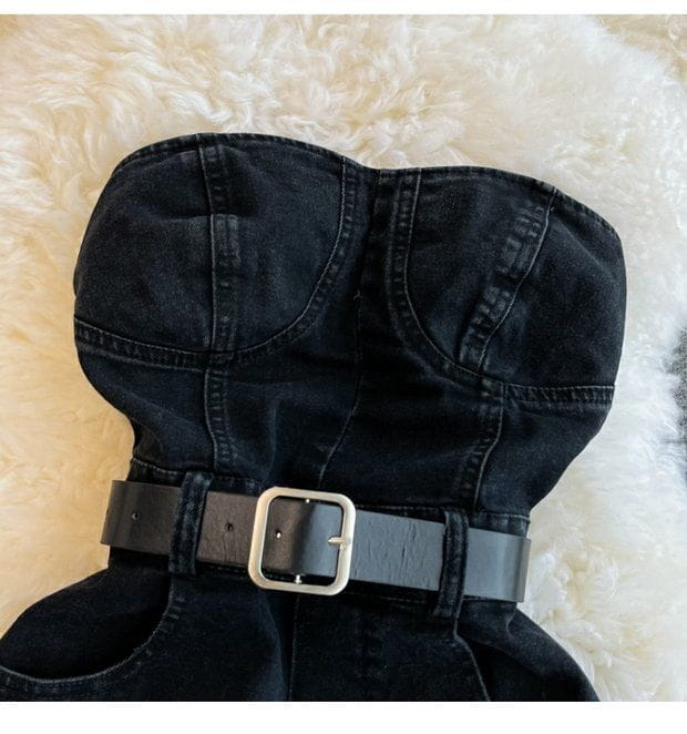 Black denim strapless top with a black leather belt and silver buckle in a denim jumpsuit off shoulder summer romper.