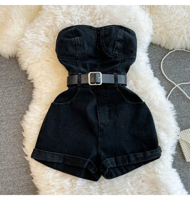 Black denim strapless jumpsuit with silver buckle belt designed as an off shoulder summer romper.