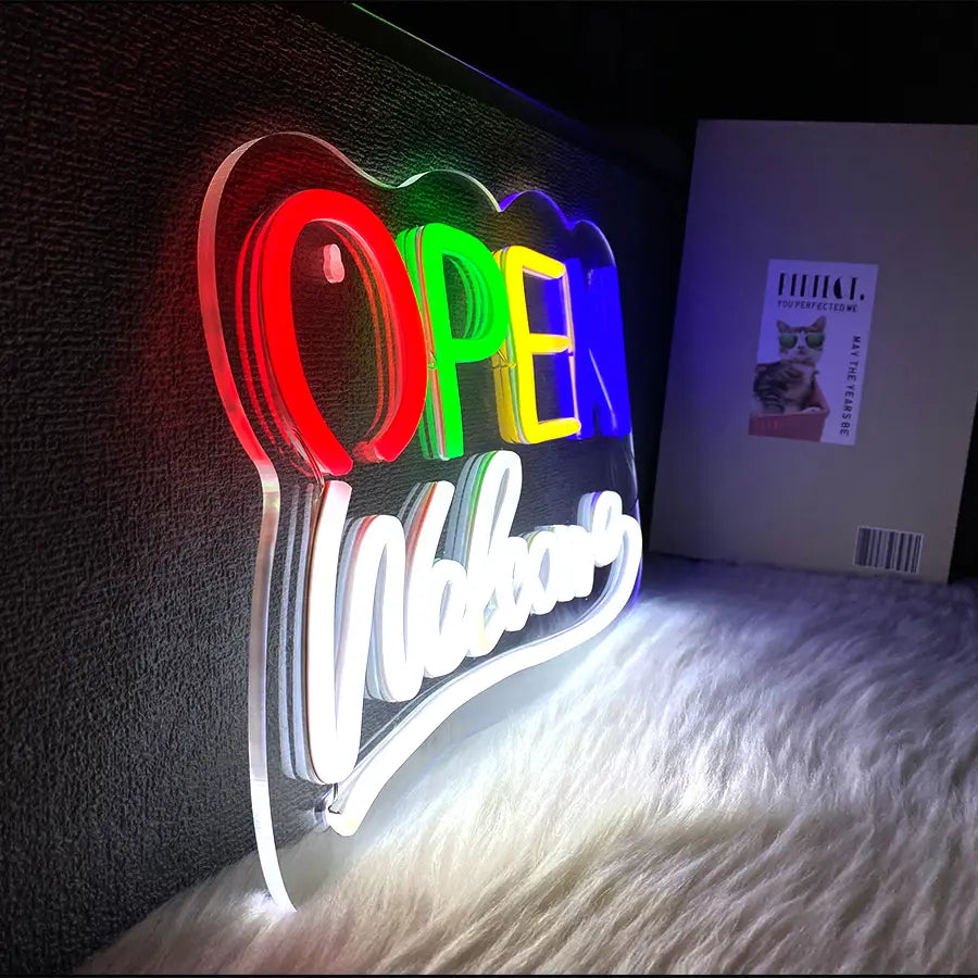 Une enseigne néon vibrante de couleur arc-en-ciel, alimentée par USB, en forme de nuage, avec le mot « ouvert » en lettres grasses, et « bienvenue » inscrit en cursive en dessous