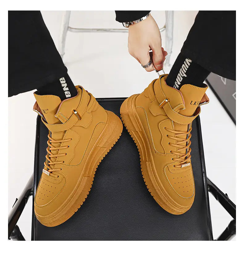 Men white high top sneakers featuring tan leather with laces, chunky rubber soles, and gold metallic buckle details.