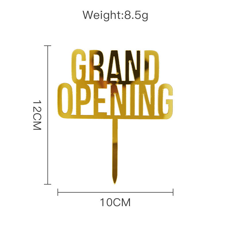A shiny gold acrylic graduation cake topper with a grand opening design and a pointed stick for easy insertion into cakes.