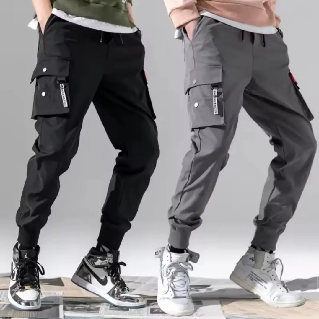 Men tactical cargo pants multi pocket joggers in black and gray featuring multiple pockets elastic cuffs and branded tags on the side.