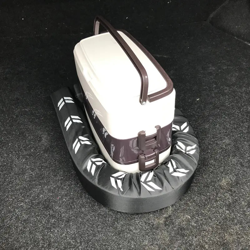 white and brown plastic cooler with curved handle and side latches placed on a black flexible anti-collision car trunk organizer mat with white arrow patterns