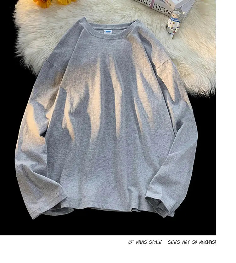 A soft heather gray oversized long sleeve blank t-shirt with a relaxed fit and crewneck design.