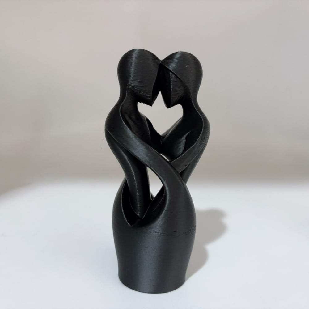 Black 3d-printed abstract sculpture of two intertwined figures forming a heart shape modern decor piece.