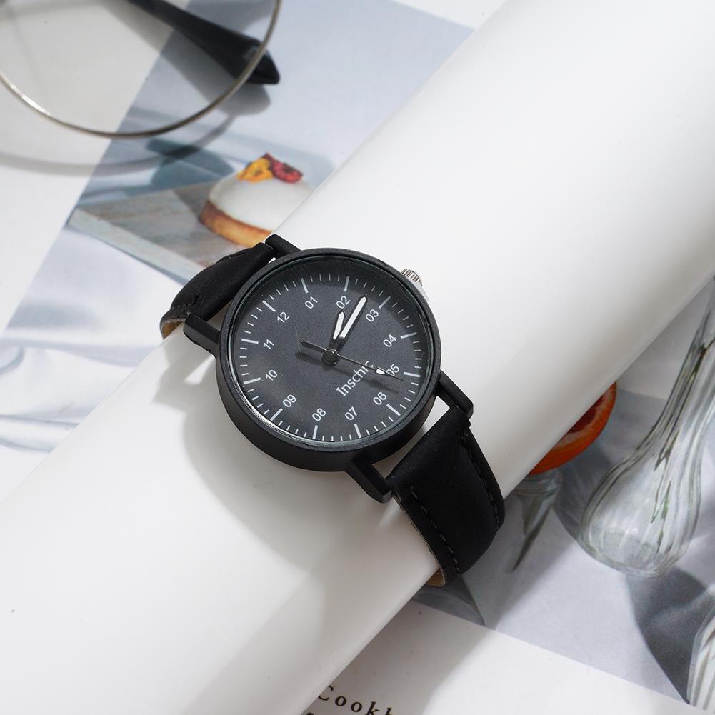 Black leather-strapped women quartz watch with minimalist black dial and white numerals featuring pu leather waterproof wristwatch design.