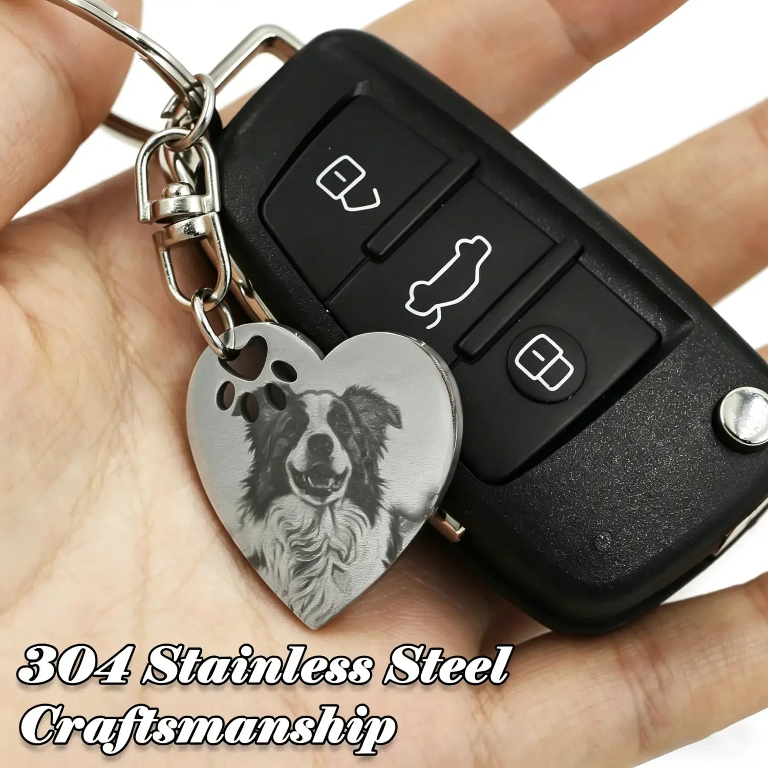A heart-shaped silver 304 stainless steel keychain engraved with a custom pet portrait and paw prints for personalized keepsakes.