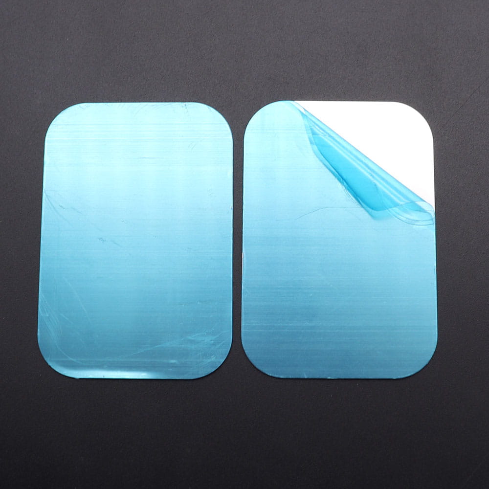 two rectangular light blue adhesive patches with rounded corners and textured surface for metal plate disk used in magnetic car phone holder installation