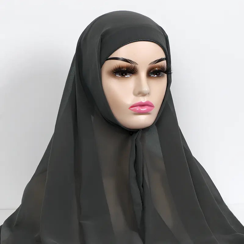 black sheer chiffon instant hijab with cap bonnet draped over a mannequin head
