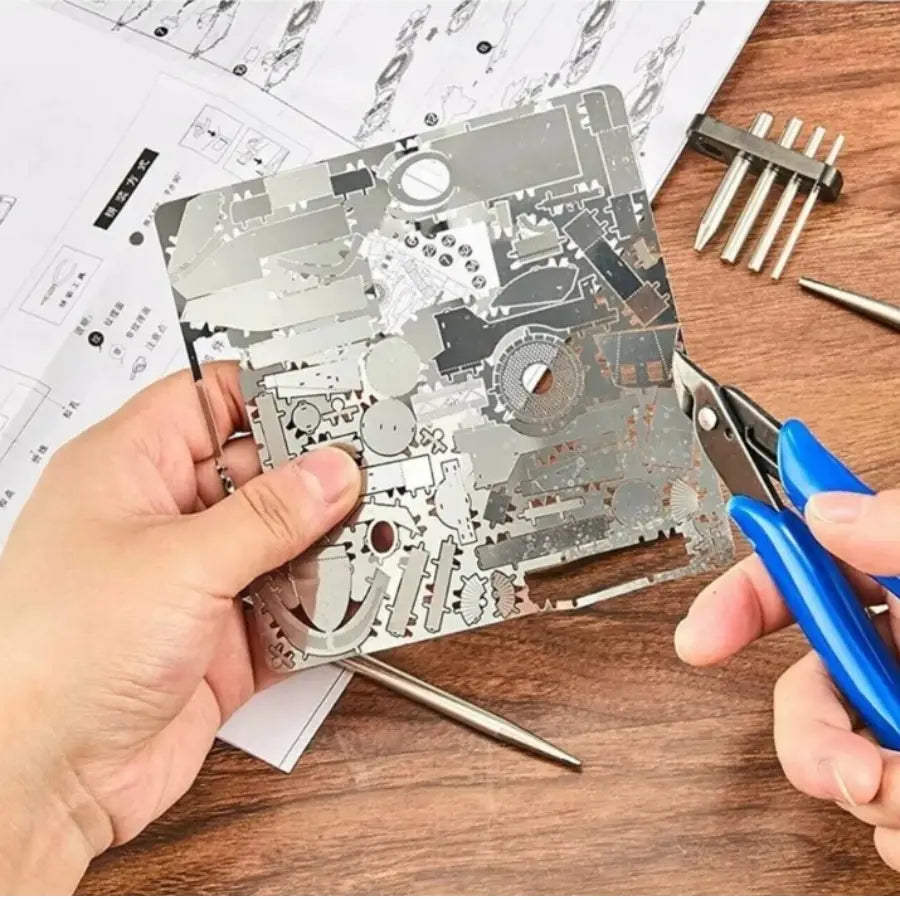 model tool set for hobby craft assembly featuring a silver metallic laser cut puzzle sheet with intricate mechanical design patterns
