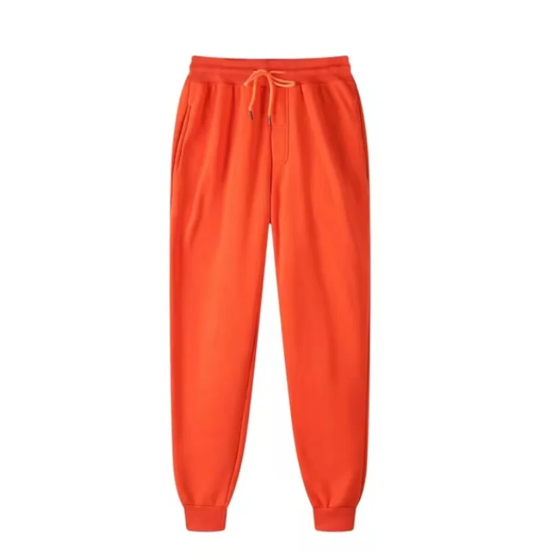 Pantalones de chándal de forro polar para hombre en naranja brillante, con cintura con cordón a juego y puños acanalados, diseñados para el uso casual en invierno.