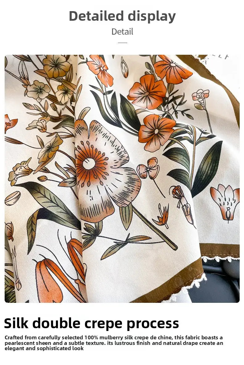 A delicate cream-colored silk floral square scarf featuring a vibrant botanical print with orange and brown flowers green leaves and subtle gold accents along the edges.