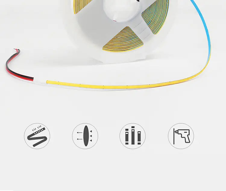 Una tira LED flexible amarilla, ultrafina de 3 mm con COB regulable, con cables rojo y negro expuestos, y cabezal DC de 2 pines incluido, enrollado de forma ordenada en una bobina blanca, para decoración doméstica DIY.