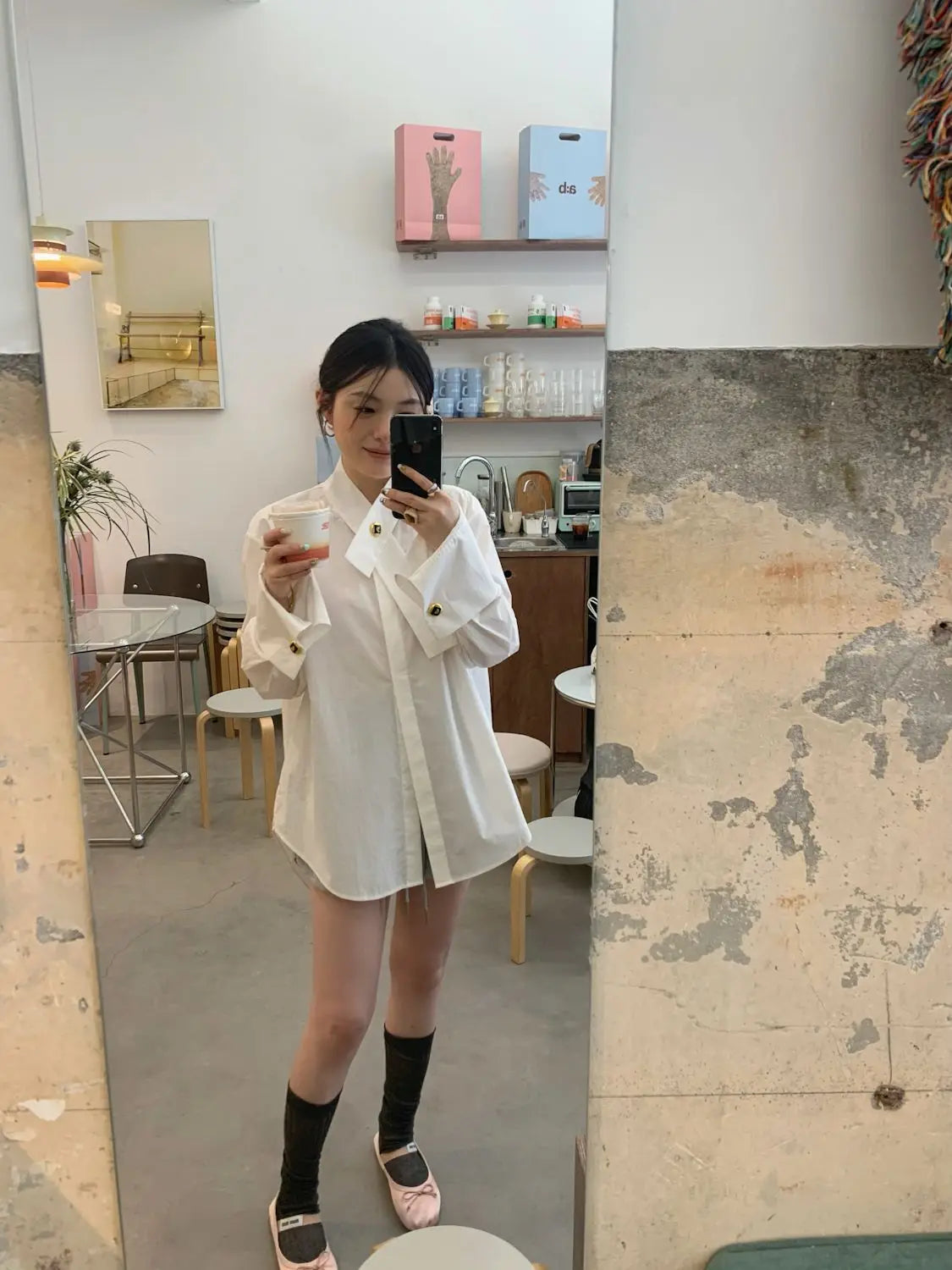 white oversized button-up shirt showcasing its loose fit and light fabric ideal for casual wear