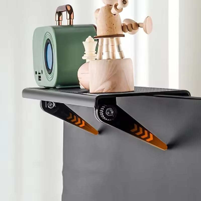 An adjustable screen top storage shelf monitor stand in black and orange with a matte finish featuring angular brackets and glowing arrow decals on the underside.