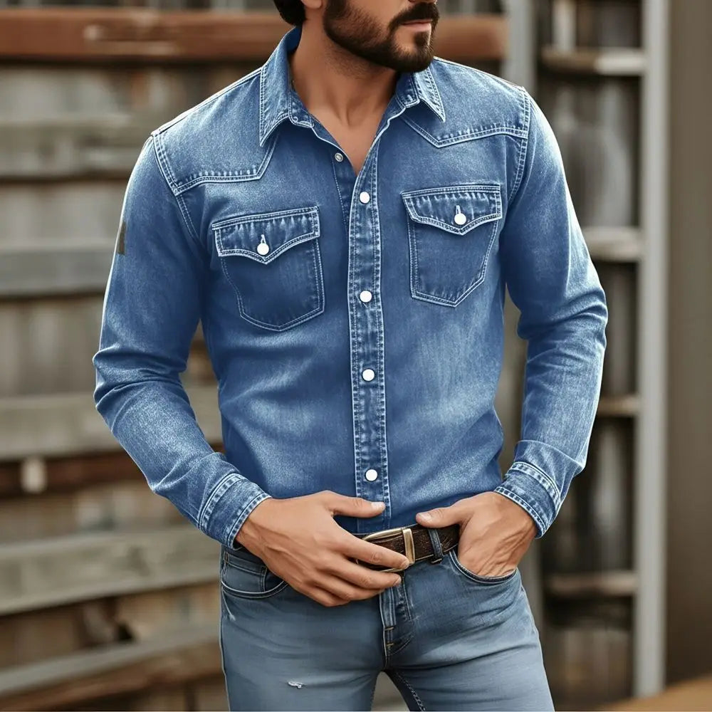 Men’s vintage denim shirt in blue with long sleeves, two chest pockets, white buttons, made of durable denim fabric for casual workwear.
